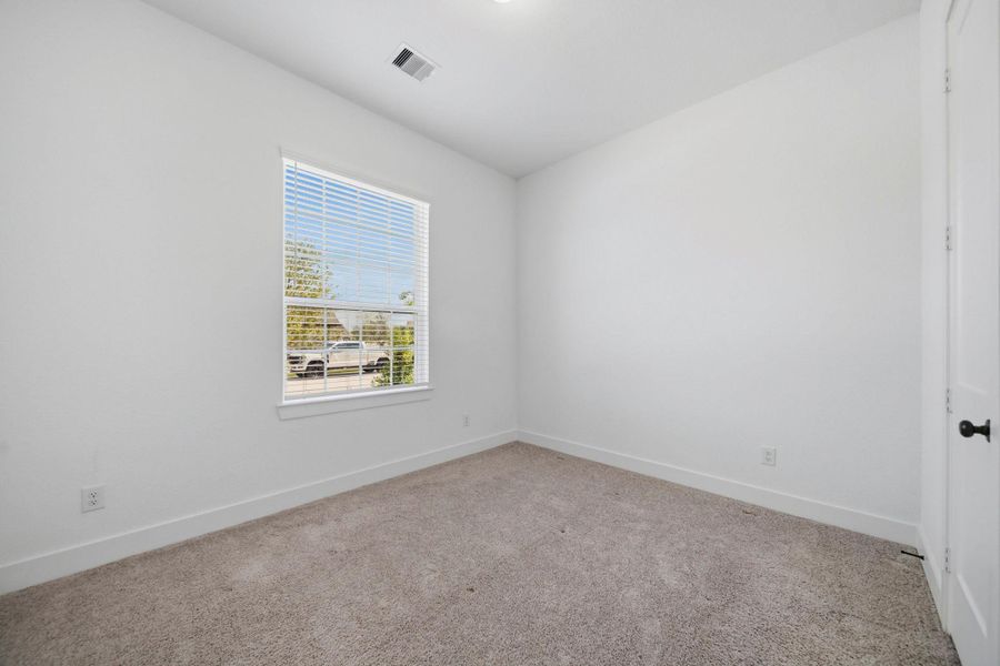 Bright and inviting, this downstairs secondary bedroom offers plenty of room for relaxation and personalization, making it the perfect retreat for family or guests.