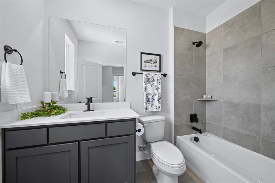 Full bath with vanity, bathing tub / shower combination, and tile patterned flooring