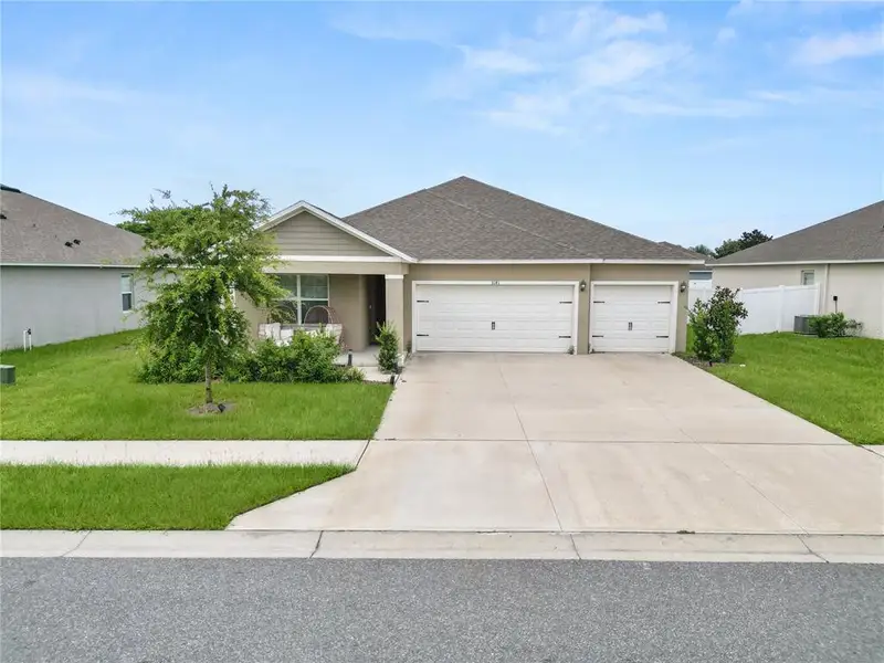 Front exterior of a new home in Wind Meadows South, Bartow, FL, highlighting curb appeal (Image 28). Front exterior of a new home in Wind Meadows South, Bartow, FL, highlighting curb appeal (Image 28).