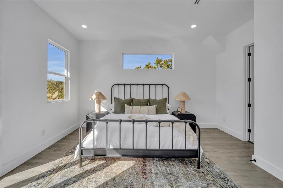 Bedroom with hardwood / wood-style flooring