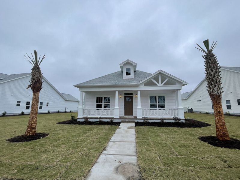 Front exterior of a new home in The Sanctuary at Sunset Beach, Sunset Beach, NC, highlighting curb appeal (Image 1).