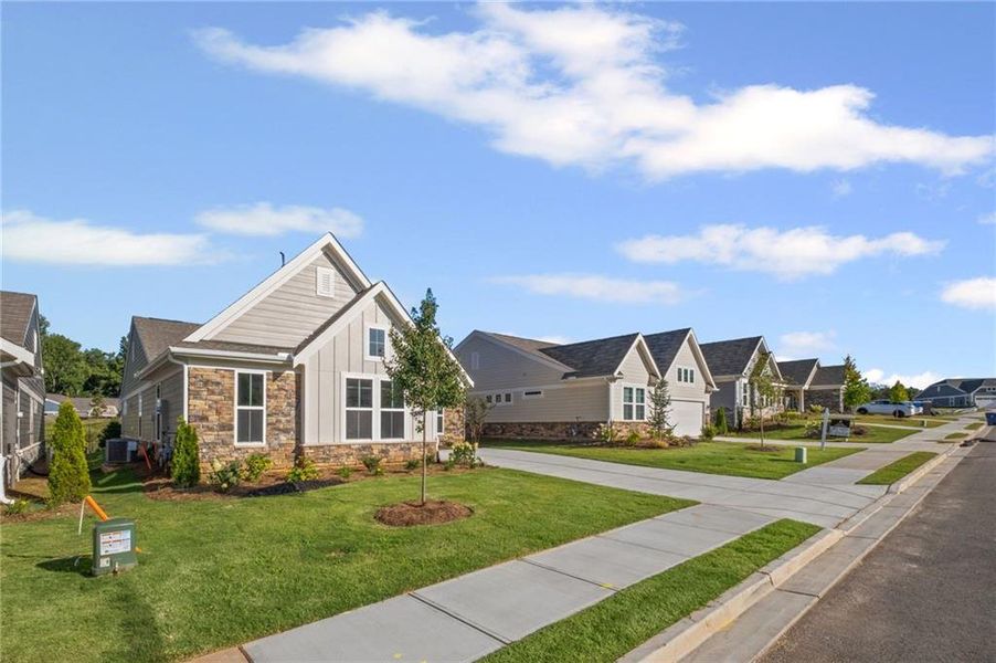 Front exterior of a new home in Laurel Farms, Dallas, GA, highlighting curb appeal (Image 28). Front exterior of a new home in Laurel Farms, Dallas, GA, highlighting curb appeal (Image 28).