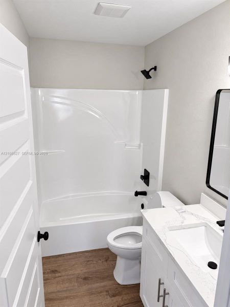 White single-piece shower and tub combination with matte black fixtures White single-piece shower and tub combination with matte black fixtures