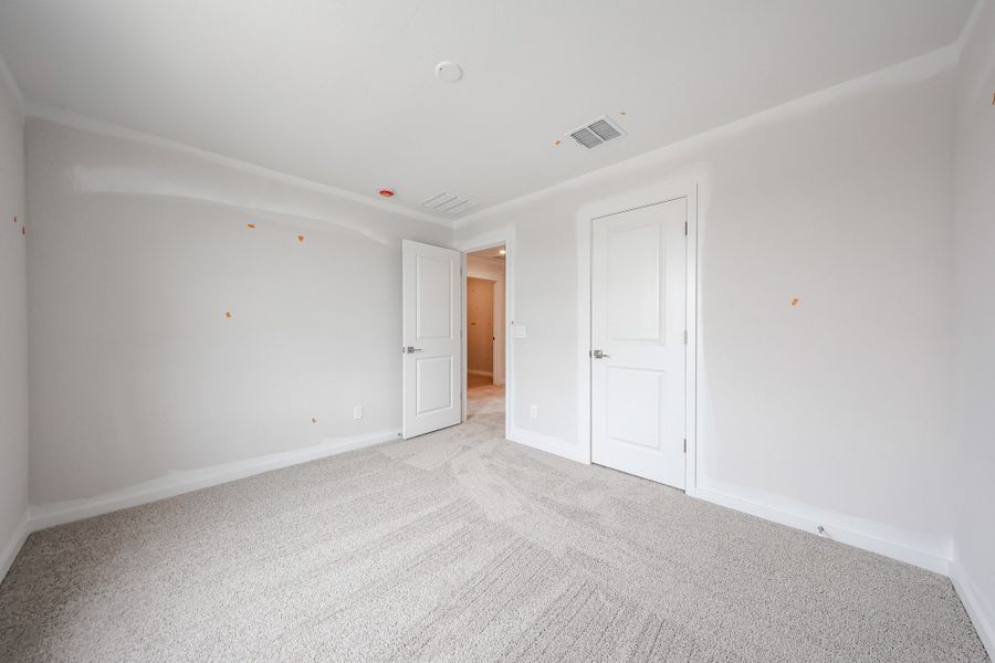 A hallway with white doors. A hallway with white doors.
