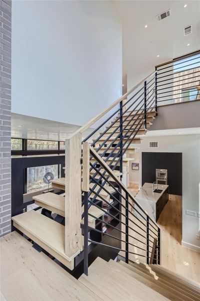 Artfully designed, this contemporary staircase with horizontal railings and wooden treads connects the home's levels. Artfully designed, this contemporary staircase with horizontal railings and wooden treads connects the home's levels.