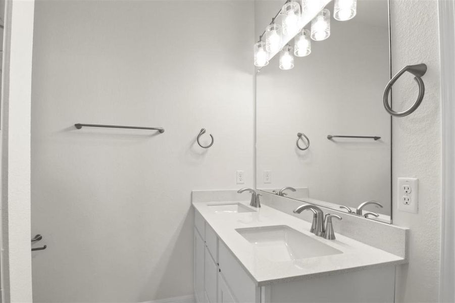 Full bath featuring a sink and double vanity