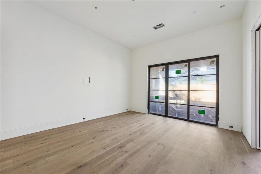 The flex room with high ceilings and sliding door with access to the Pavilion. This additional downstairs room can be a playroom, game room or guest suite.