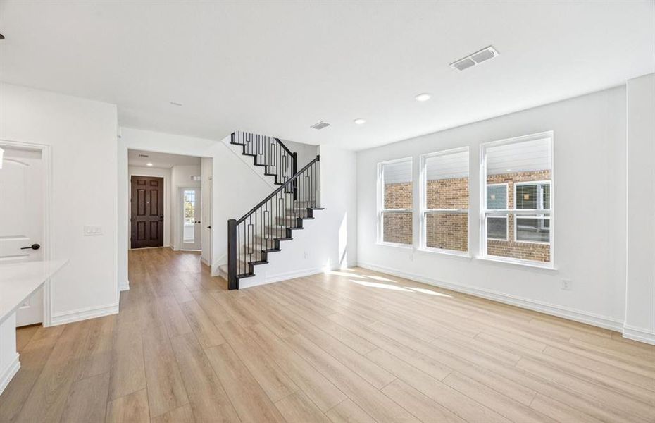 Gathering room featuring a stunning staircase Gathering room featuring a stunning staircase