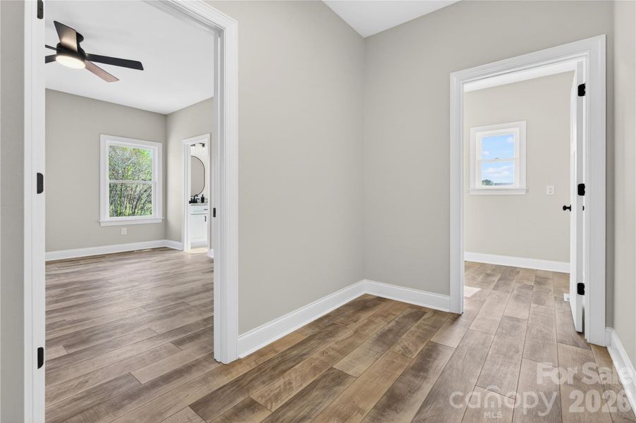 hall and entry to primary and laundry from garage hall and entry to primary and laundry from garage