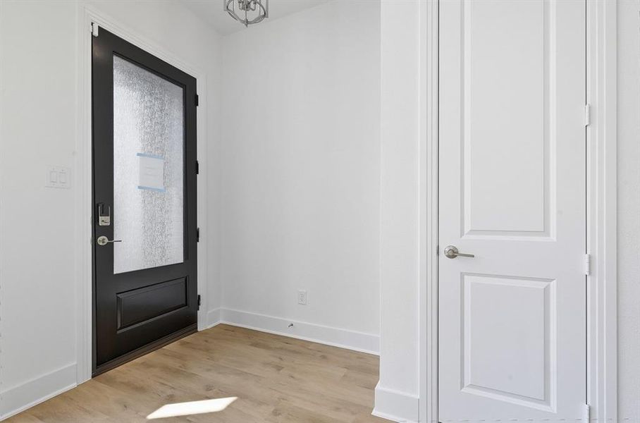 Foyer entrance featuring light wood-style floors and baseboards Foyer entrance featuring light wood-style floors and baseboards