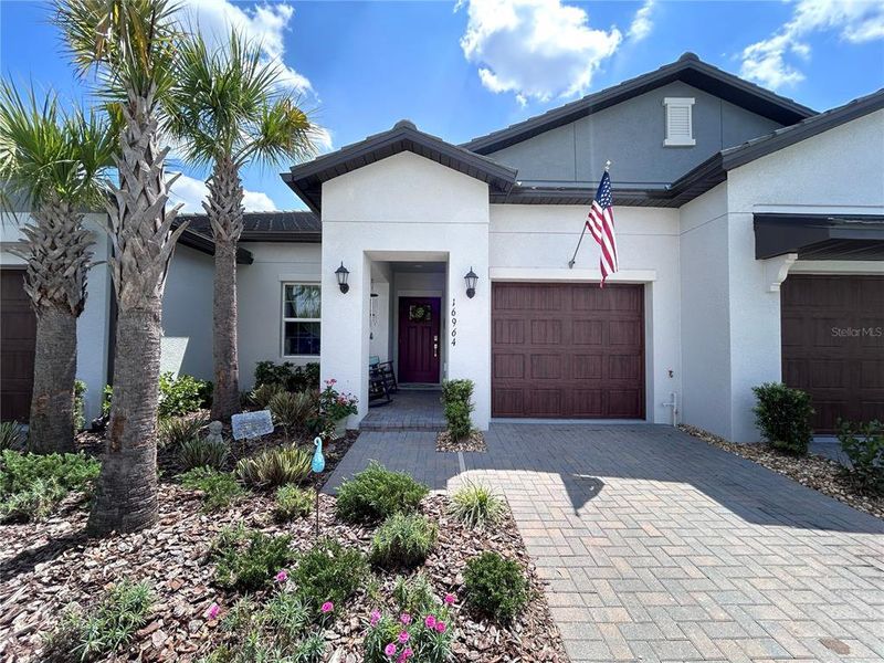 Front exterior of a new home in Angeline Active Adult, Land O' Lakes, FL, highlighting curb appeal (Image 1). Front exterior of a new home in Angeline Active Adult, Land O' Lakes, FL, highlighting curb appeal (Image 1).