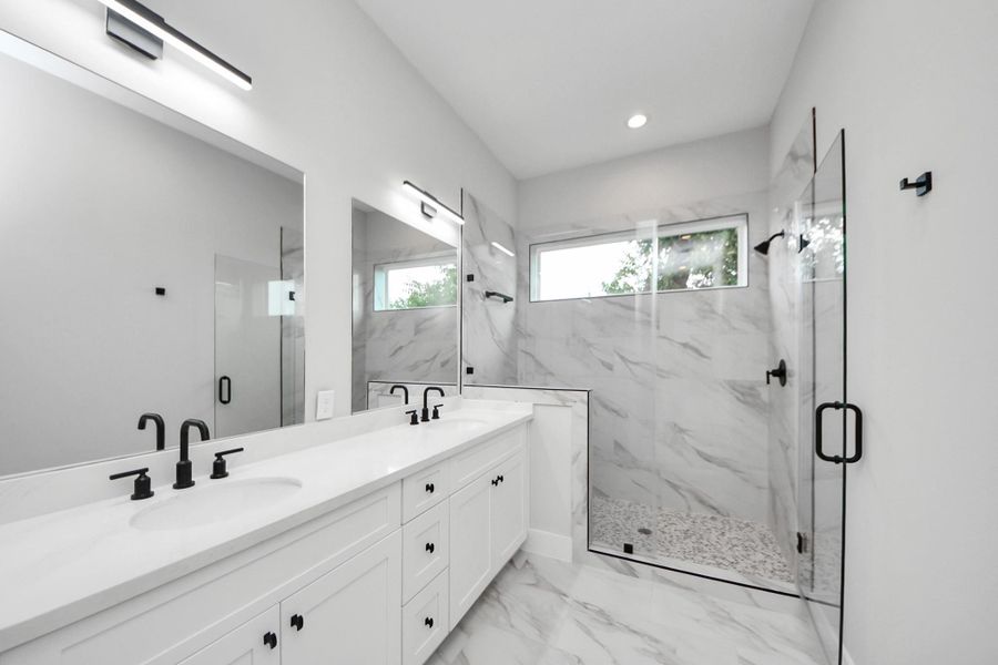 Spa-inspired primary bathroom with dual vanities
