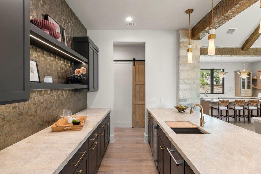 Dedicated entertaining bar with Taj Mahal quartzite countertops. Dedicated entertaining bar with Taj Mahal quartzite countertops.