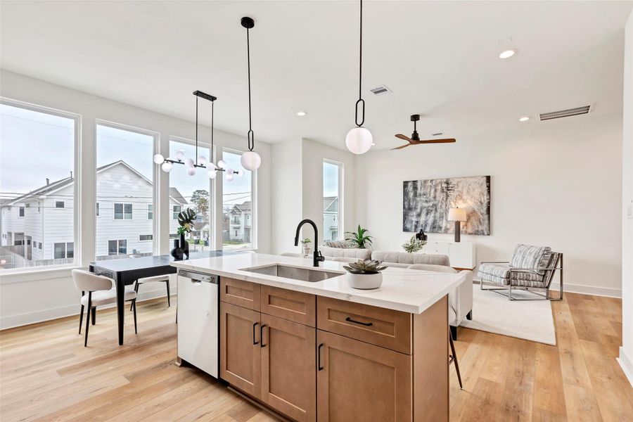 This stylish quartz center island, serving as both a convenient breakfast bar and a functional sink area – perfect for casual meals and meal prep. This stylish quartz center island, serving as both a convenient breakfast bar and a functional sink area – perfect for casual meals and meal prep.