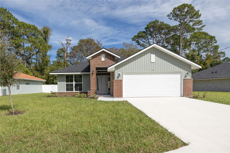 Front exterior of a new home in Palm Coast, Palm Coast, FL, highlighting curb appeal (Image 1). Front exterior of a new home in Palm Coast, Palm Coast, FL, highlighting curb appeal (Image 1).