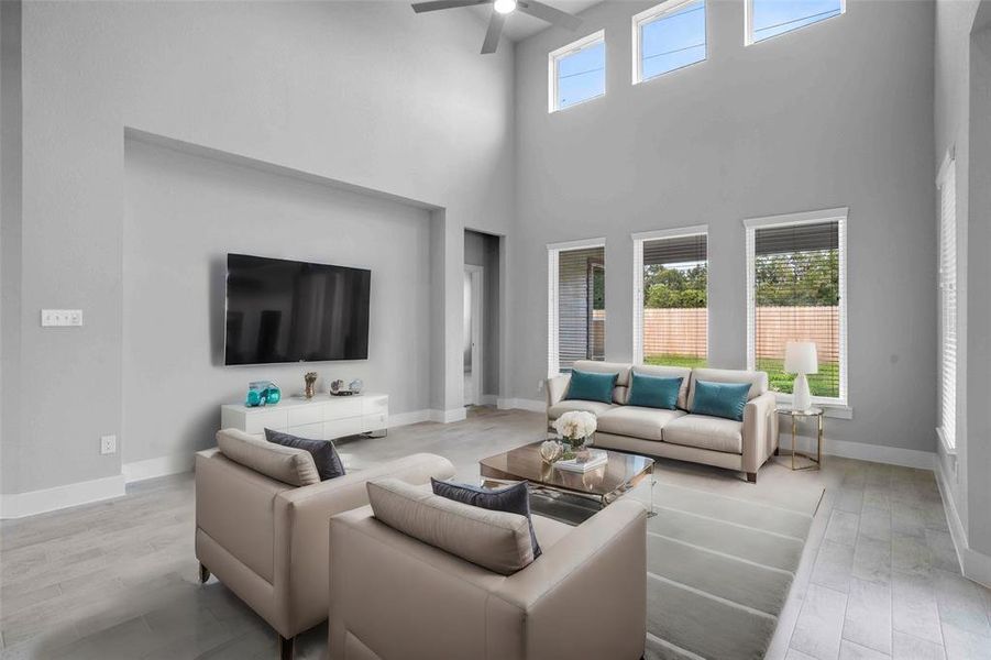 Gather the family and guests together in your lovely living room! Featuring soaring high ceilings, recessed lighting, ceiling fan, neutral paint, gorgeous wood look tile floors and a wall of windows that provide plenty of natural lighting throughout the day.