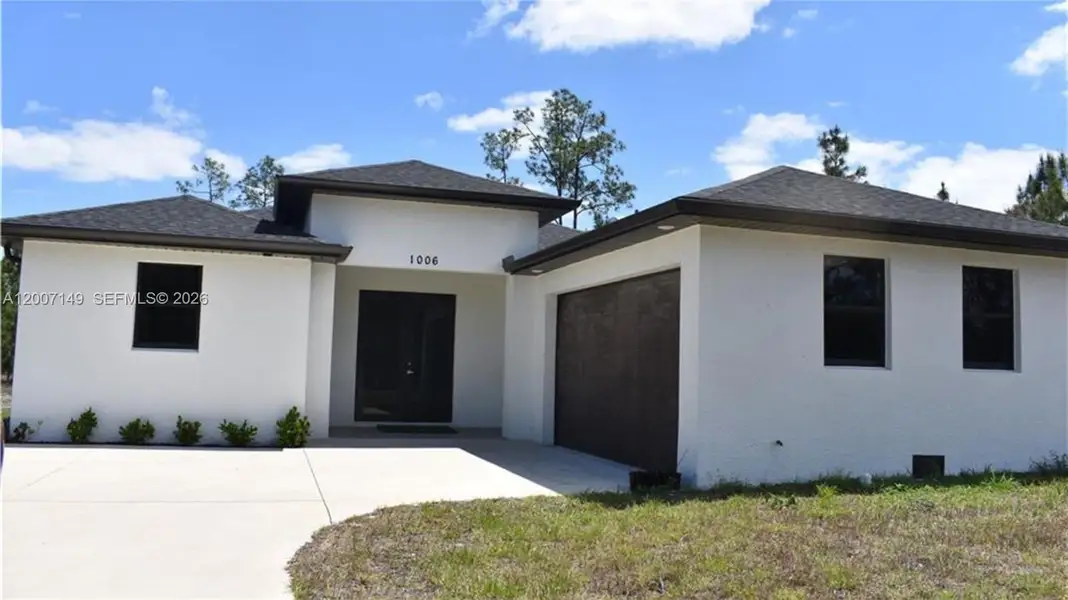 Front exterior of a new home in , Lehigh Acres, FL, highlighting curb appeal (Image 2). Front exterior of a new home in , Lehigh Acres, FL, highlighting curb appeal (Image 2).