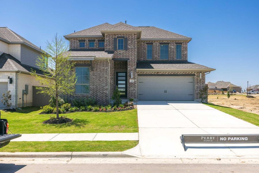 Prairie-style house with brick siding, an attached garage, a front lawn, and a shingled roof Prairie-style house with brick siding, an attached garage, a front lawn, and a shingled roof