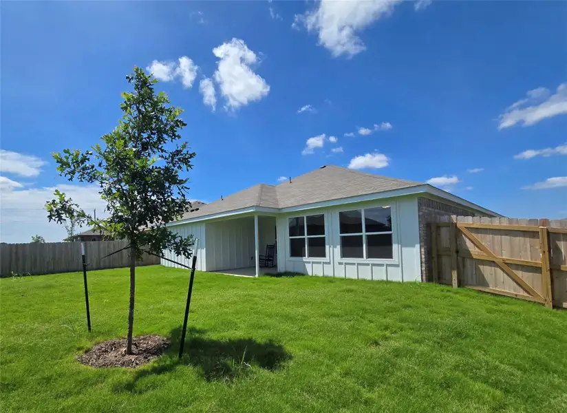 A private backyard oasis with a covered patio offers seamless outdoor living.