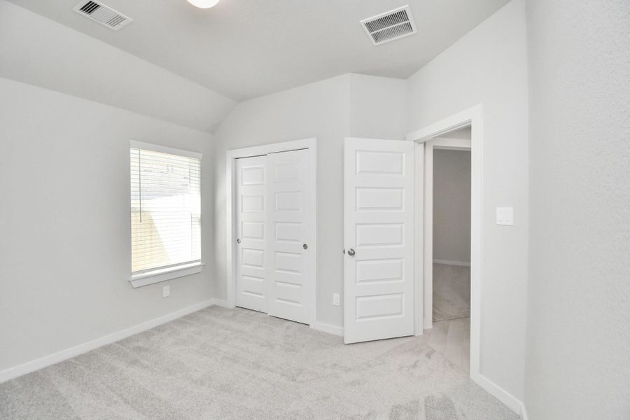 Generously sized secondary bedrooms featuring spacious closets, soft and inviting carpeting underfoot, large windows allowing plenty of natural light, and the added touch of privacy blinds for your personal retreat. Sample photo of completed home with similar floor plan. Actual colors and selections may vary. Generously sized secondary bedrooms featuring spacious closets, soft and inviting carpeting underfoot, large windows allowing plenty of natural light, and the added touch of privacy blinds for your personal retreat. Sample photo of completed home with similar floor plan. Actual colors and selections may vary.