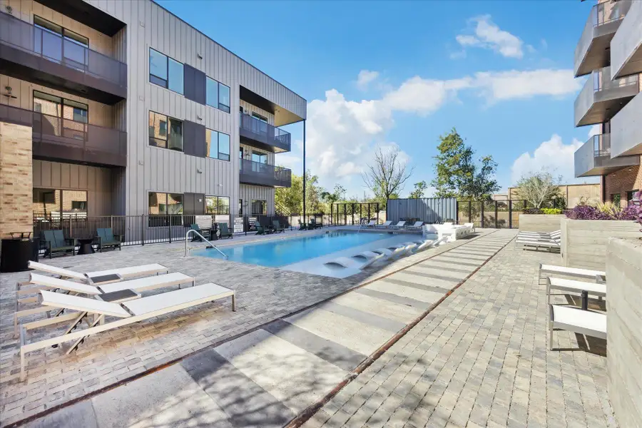 An inviting community pool awaits, nestled beside modern residential buildings with private balconies. An inviting community pool awaits, nestled beside modern residential buildings with private balconies.