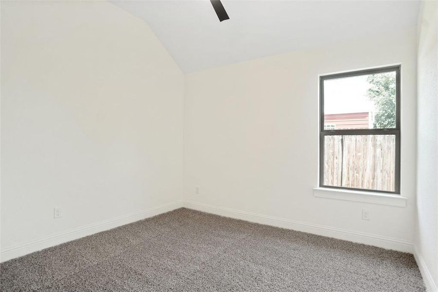 Unfurnished room featuring carpet floors and vaulted ceiling