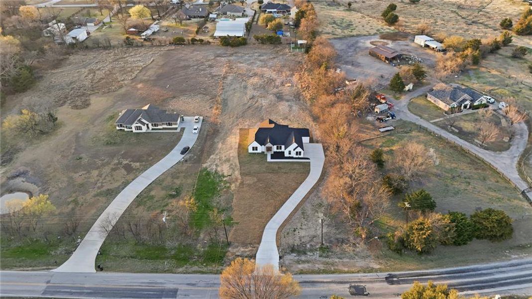 Aerial view of property's location with nearby suburban area