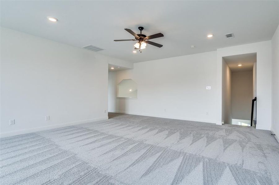 Carpeted empty room with ceiling fan