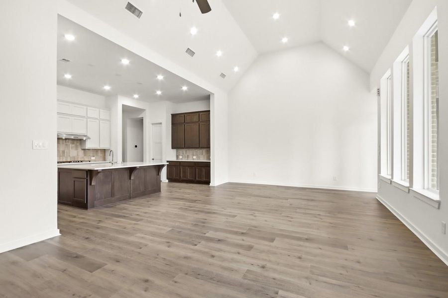 Open-concept dining area with elevated ceilings.