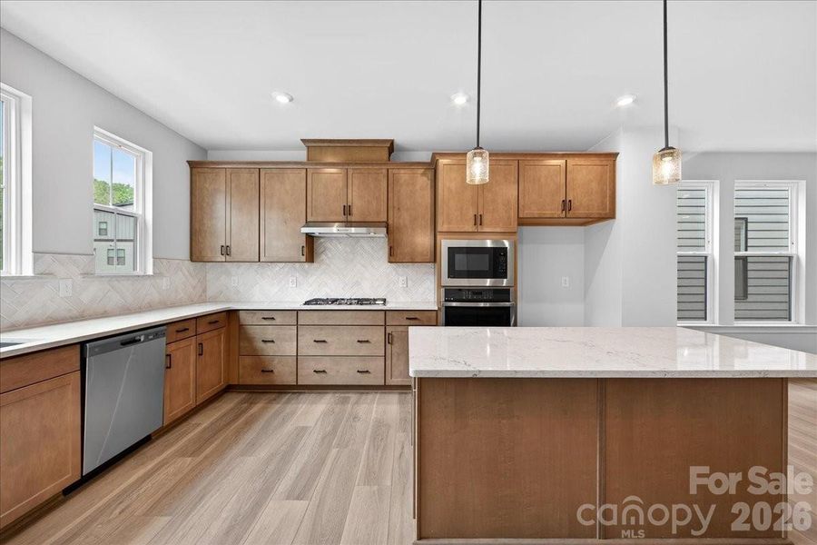 3x12 Mesmerist Spirit Gloss backsplash tile installed in a vertical Herringbone