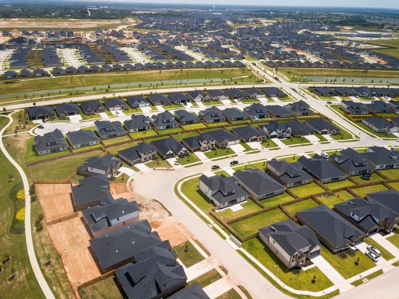 Community aerial featuring beautiful new homes, tree-lined streets, and proximity to resort-style amenities—call today to experience it in person! Community aerial featuring beautiful new homes, tree-lined streets, and proximity to resort-style amenities—call today to experience it in person!