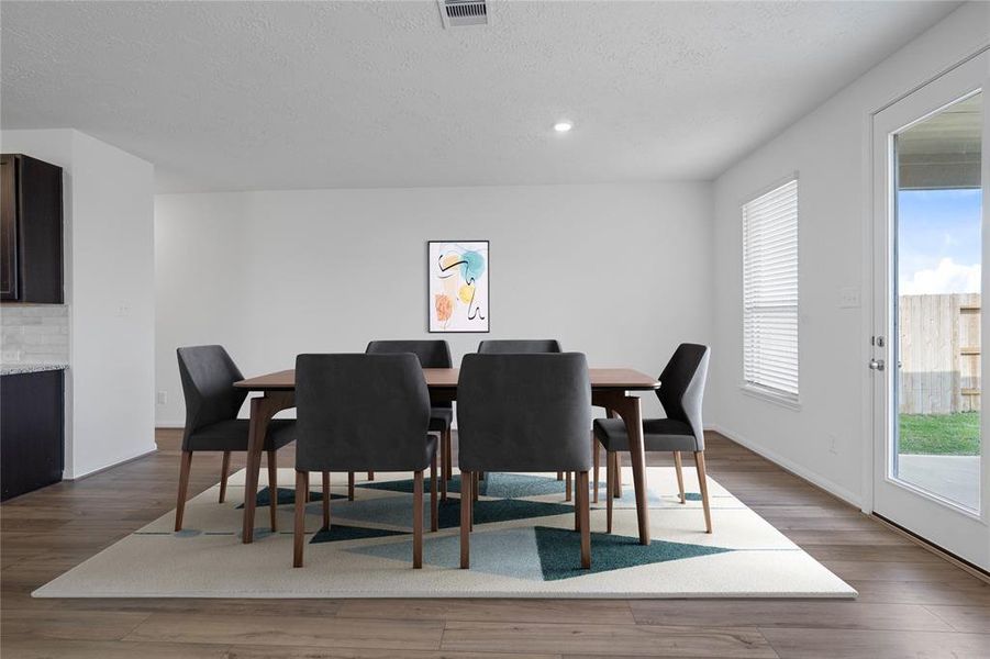 Make memories gathered around the table with your family and friends! This dining room features high ceilings, large window with privacy blinds, recessed lighting, and easy access to your kitchen and living room.