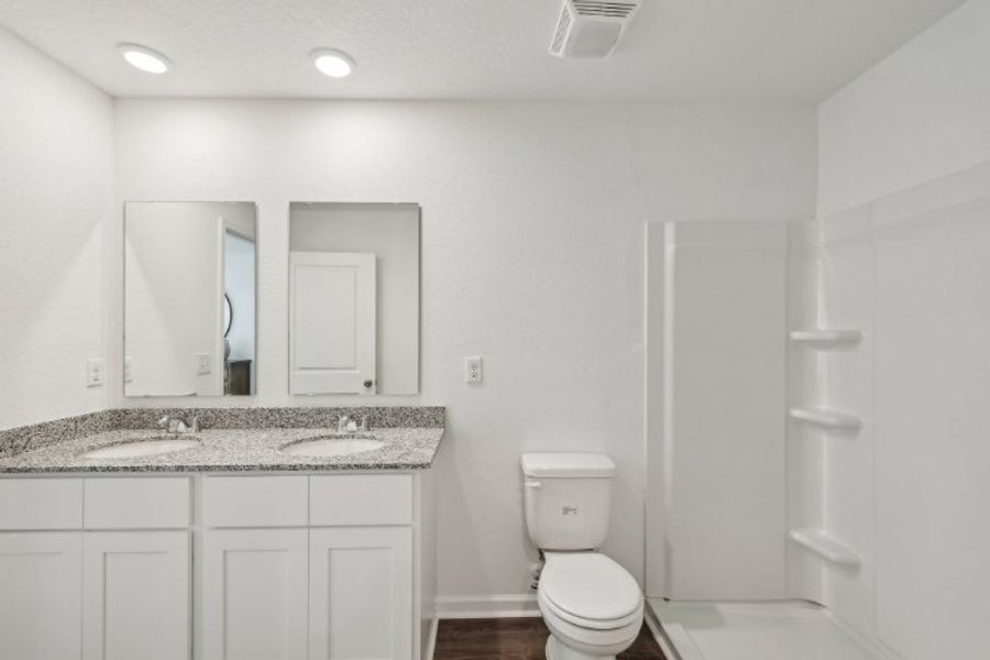A bathroom with a marble countertop.
