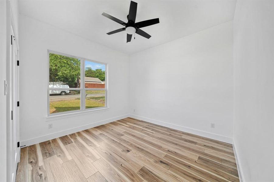 Unfurnished room with light hardwood / wood-style flooring and ceiling fan