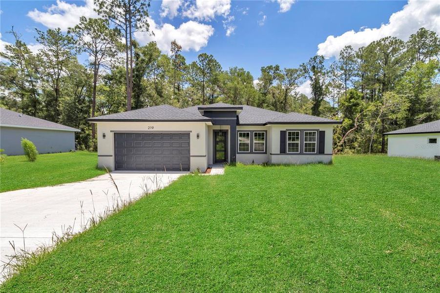 Front exterior of a new home in , Dunnellon, FL, highlighting curb appeal (Image 2). Front exterior of a new home in , Dunnellon, FL, highlighting curb appeal (Image 2).