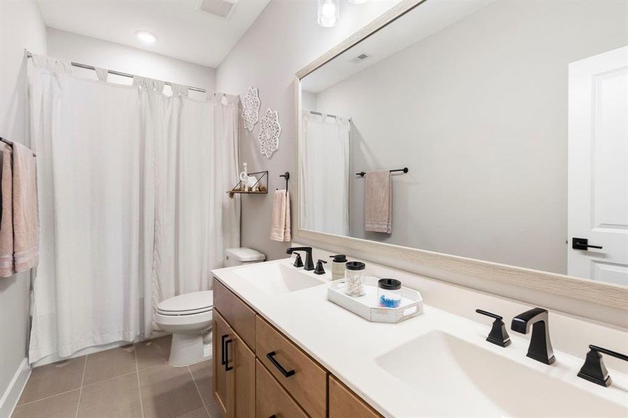 Upstairs bathroom is conveniently located for the two bedrooms and gameroom upstairs.