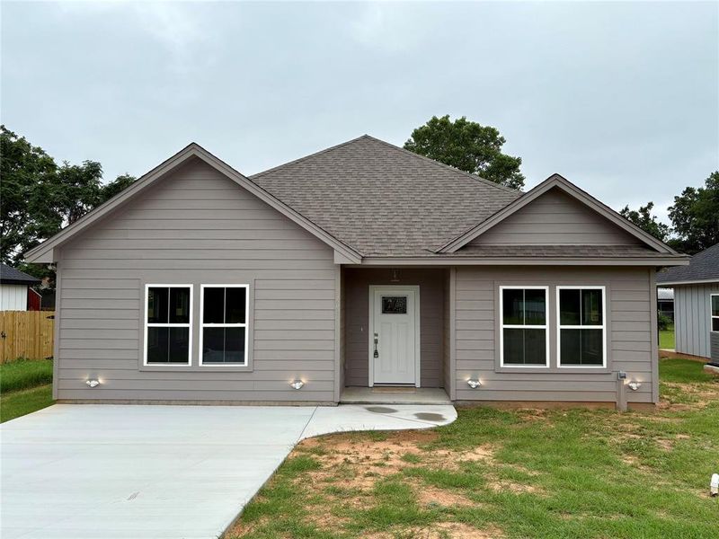 View of front of home with a shingled roof View of front of home with a shingled roof