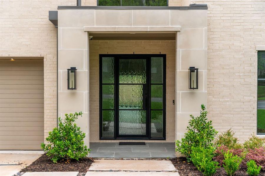 At the entry you are greeted by a massive iron door with fleshed glass and elegant Bevolo gas lanterns.