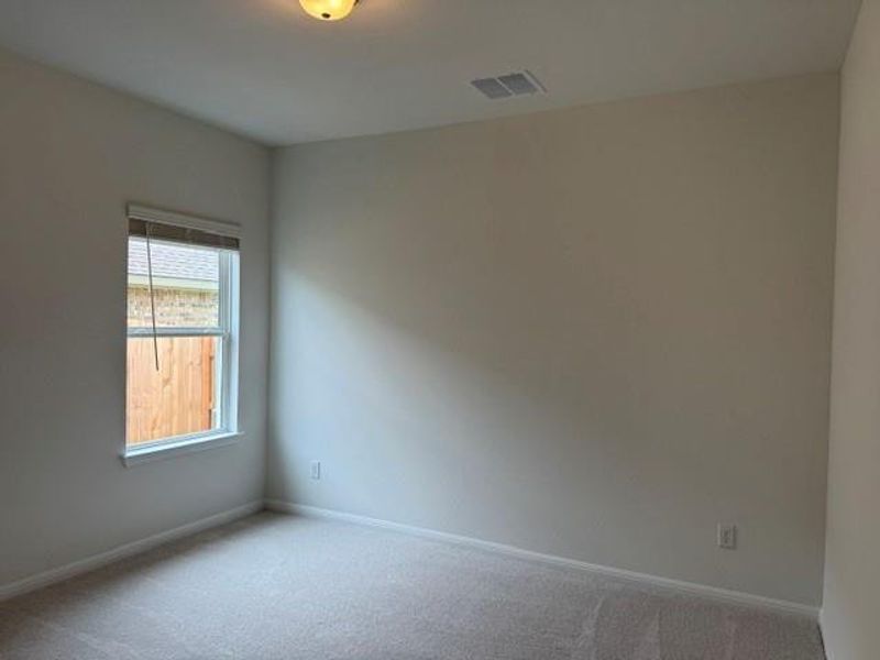 Interior room featuring neutral wall tones and carpet flooring