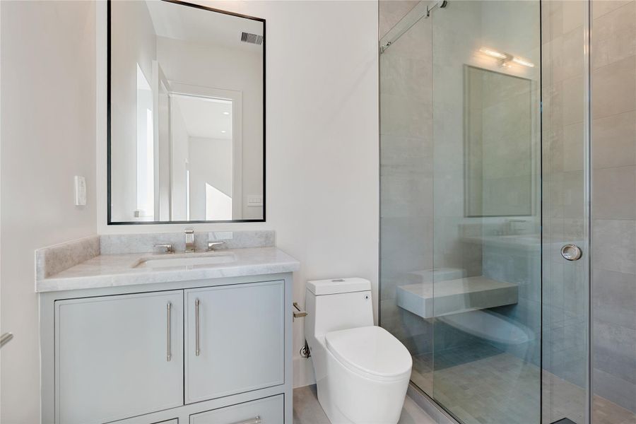 Spacious secondary ensuite baths.  NOTE: This photo is a rendering of one of the builder’s prior homes and similarly used as an example for this home. Please contact the listing agent to tour this property and for more detailed information.