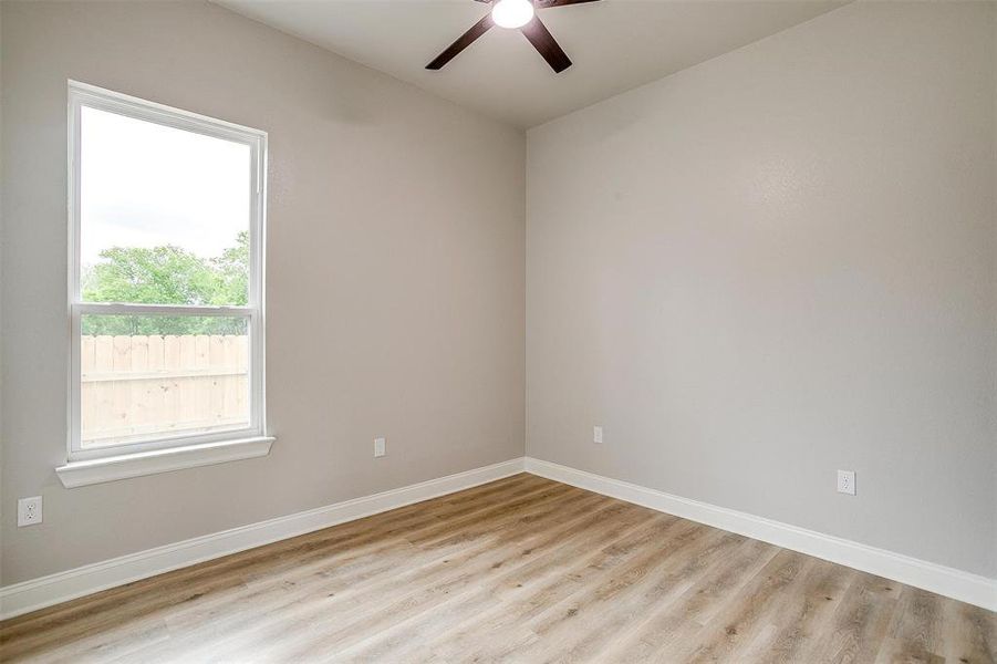 Unfurnished room with baseboards, ceiling fan, and wood finished floors Unfurnished room with baseboards, ceiling fan, and wood finished floors