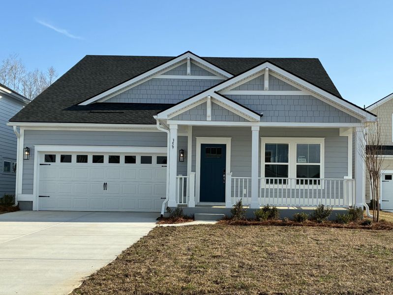 Front exterior of a new home in The Coves at Lakes of Cane Bay, Summerville, SC, highlighting curb appeal (Image 2). Front exterior of a new home in The Coves at Lakes of Cane Bay, Summerville, SC, highlighting curb appeal (Image 2).