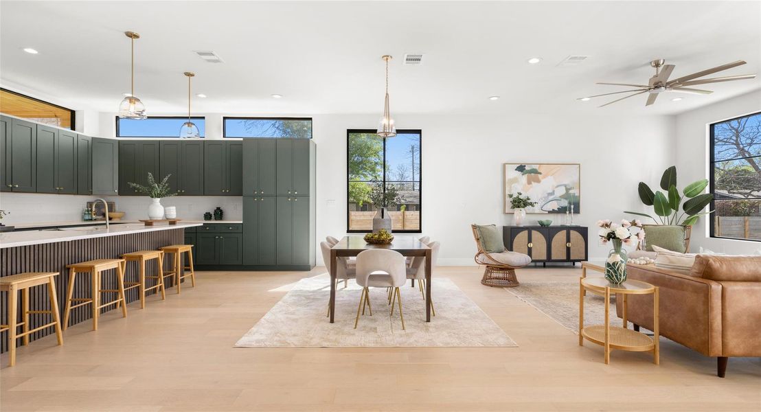 Dining space with light wood-type flooring, a ceiling fan, healthy amount of natural light, and recessed lighting