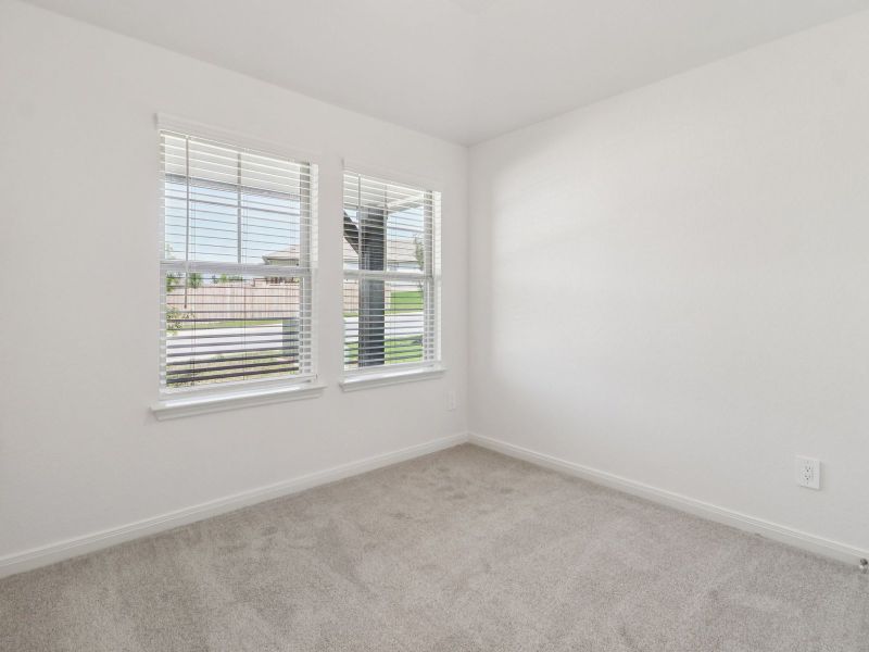 Guest bedroom in the Callaghan floorplan at a Meritage Homes community. Guest bedroom in the Callaghan floorplan at a Meritage Homes community.