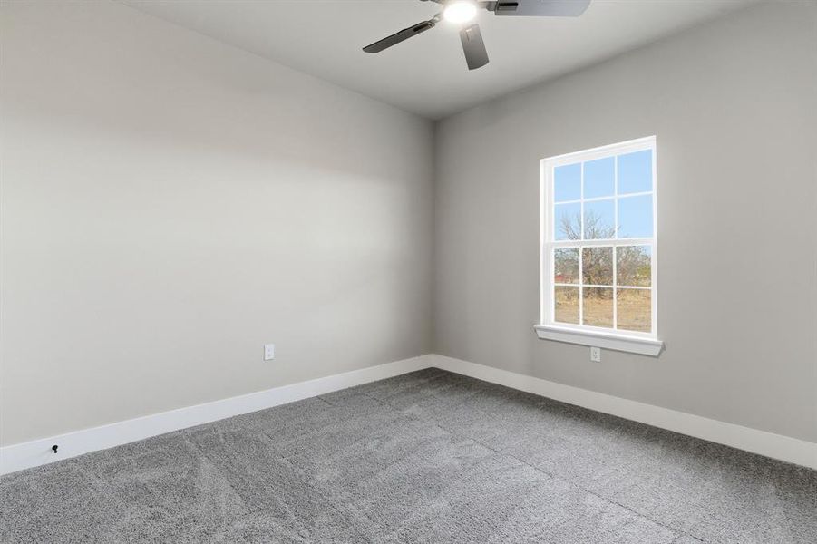 Unfurnished room with carpet floors and ceiling fan