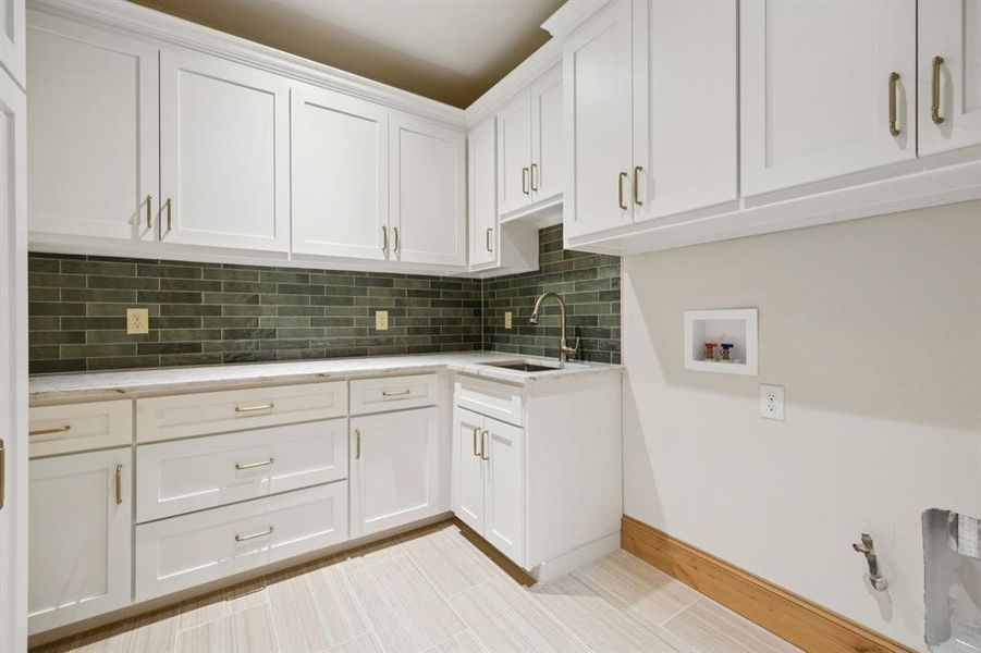 Laundry area featuring washer hookup and cabinet space