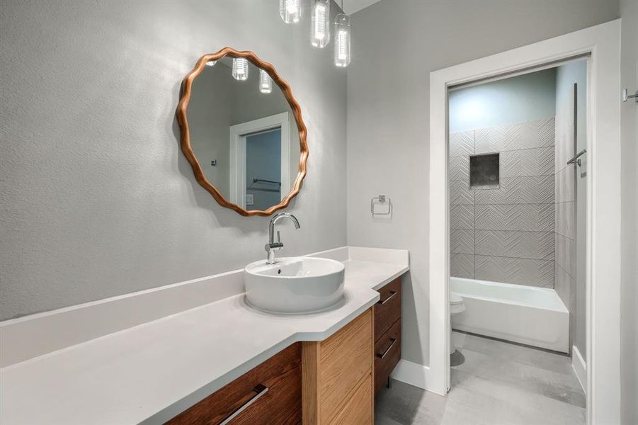 Full bathroom featuring tile patterned floors, vanity, toilet, and tiled shower / bath