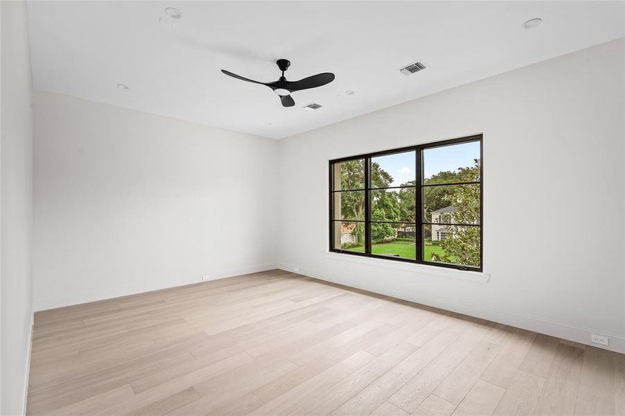 Bedroom 2 boasts elegant white oak hardwood flooring and an ensuite bathroom with a spacious walk-in closet, offering a perfect blend of comfort and convenience.