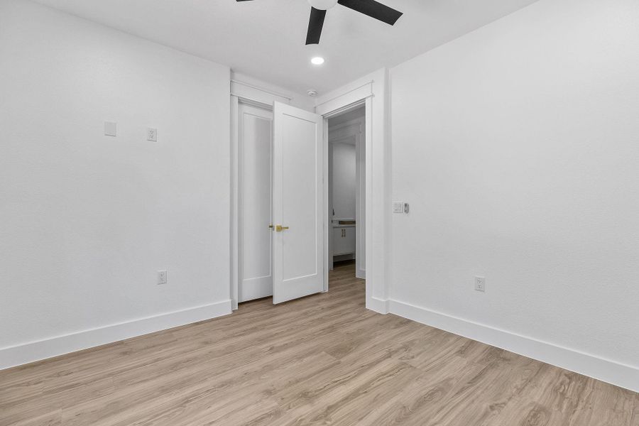Unfurnished bedroom with light wood-type flooring, recessed lighting, and a ceiling fan