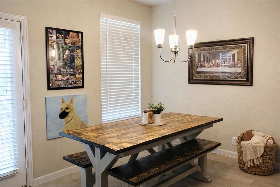 Dining room with baseboards and suspended lighting